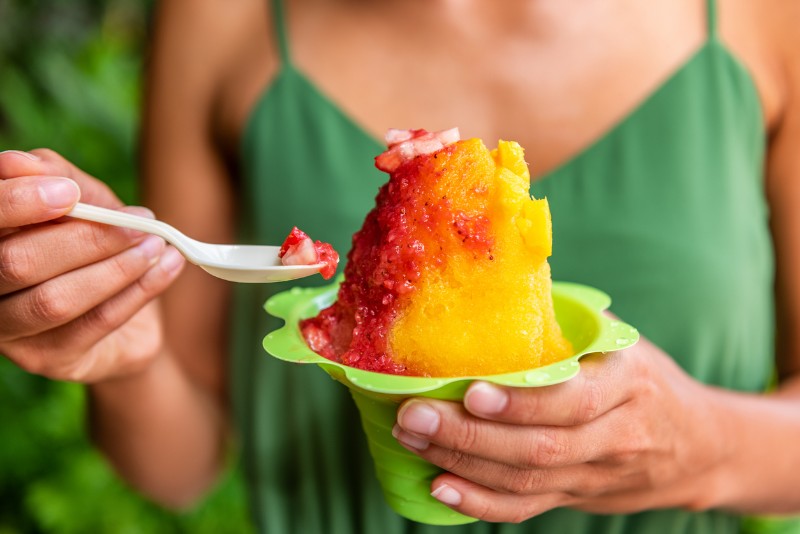 a woman holding a Kakaʻako’s vibrant food